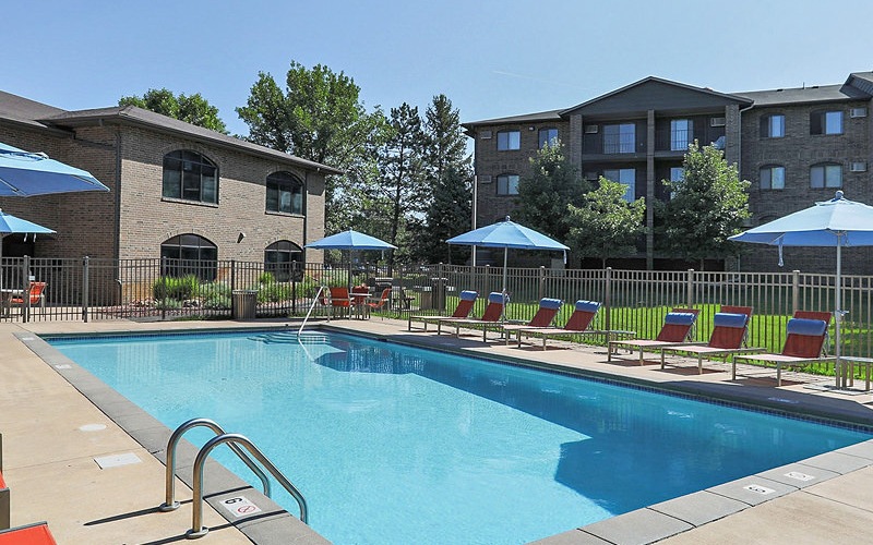 Large pool with shaded seating and clubhouse access.